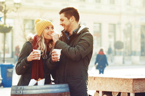 Happy Couple in Love Celebrating Christmas Outdoors - Photo, image