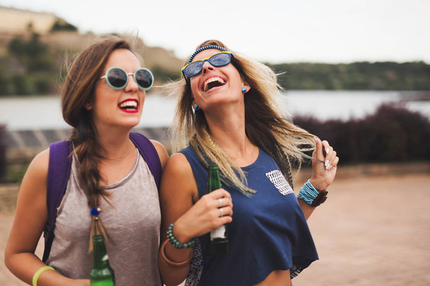 friends laughing and smiling outdoors - Фото, изображение
