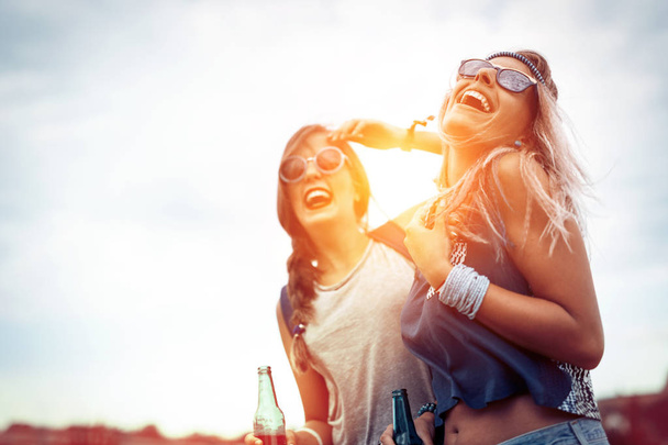 Happy friends laughing and having fun outdoors - Foto, imagen