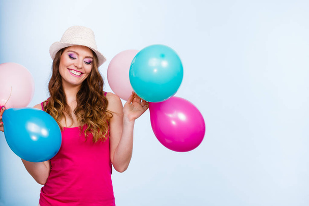 Woman playing with many colorful balloons - Foto, immagini