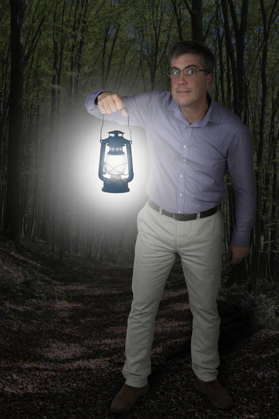 Man in the forest with lantern - Photo, Image