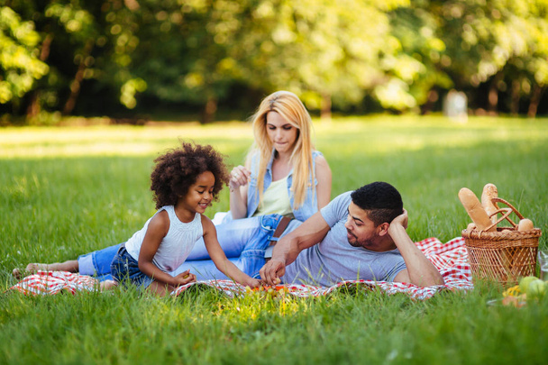 couple with their daughter having picnic - Foto, Imagem