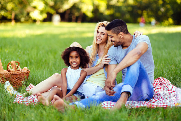 couple with their daughter having picnic - Foto, Bild