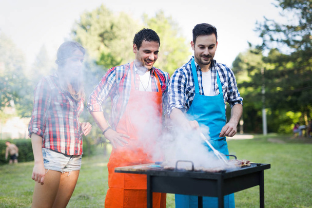 Happy friends enjoying barbecue party - Фото, зображення