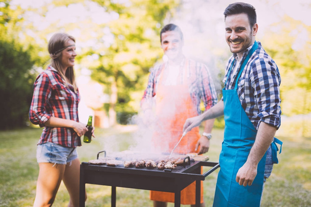 Happy friends enjoying barbecue party - Fotografie, Obrázek