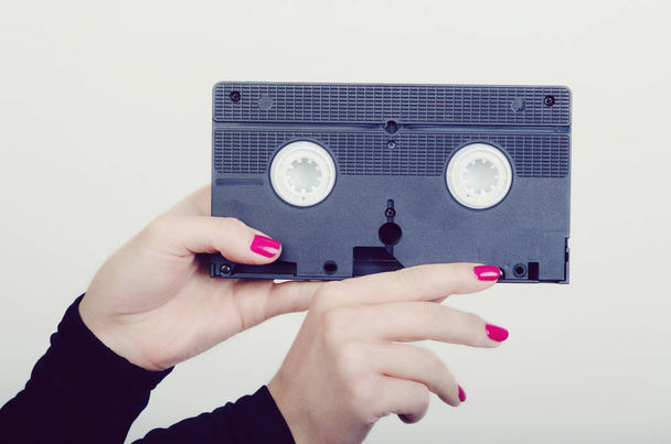 woman hands with a cassette - 写真・画像