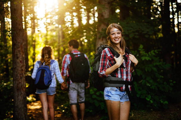 woman and friends hiking in forest - Foto, Imagem