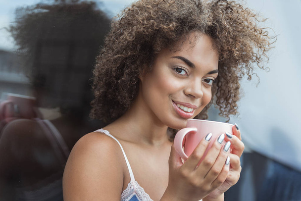 Cheerful female tasting appetizing tea - Photo, Image