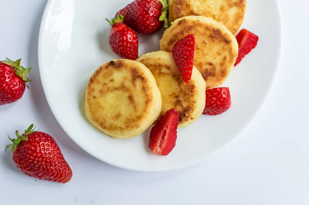 Delicious curd fritters with strawberry  - Fotó, kép