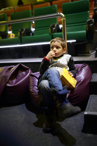 Boy with popcorn in cinema - Valokuva, kuva