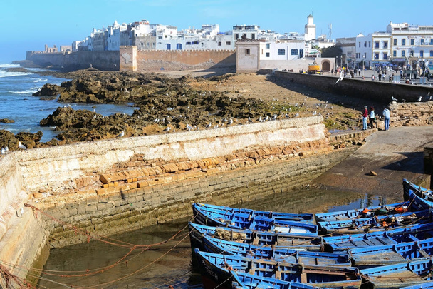 Essaouira, Morocco -  January 5, 2016: Coastal town Essaouira with sea and blue boats   - 写真・画像