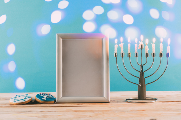 frame, menorah and cookies for hanukkah - Foto, imagen