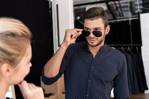 man wearing sunglasses in boutique - Foto, imagen
