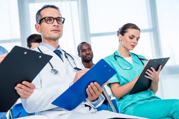 multiethnic group of doctors with clipboards - Photo, Image