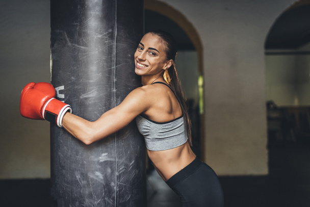 female boxer with punching bag - 写真・画像