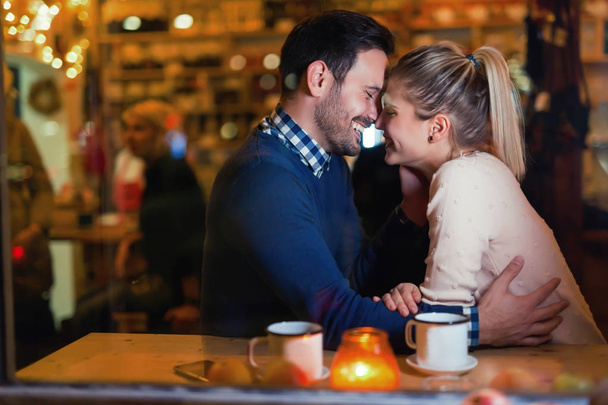 Happy couple kissing at bar  - Фото, зображення