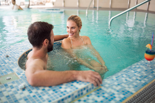couple relaxing in swimming pool - Фото, изображение