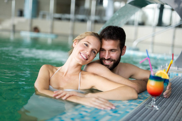 happy couple relaxing in pool - Photo, image