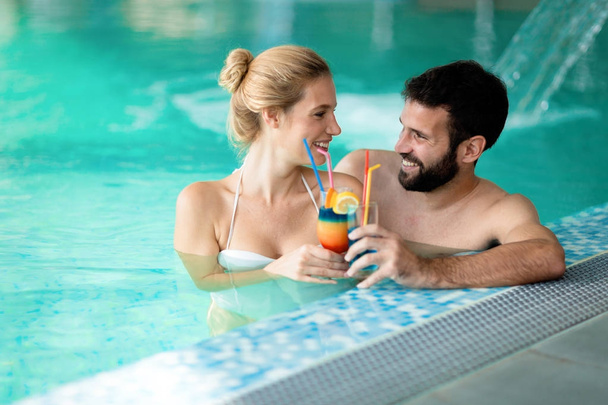 happy couple relaxing in pool - Photo, image