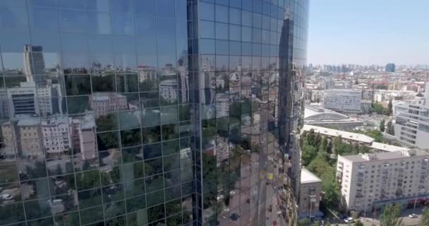 AERIAL. loseup skyscraper glass windows, business buildings district, global commerce.  Smooth camera movement in front of office building windows reflecting sunny blue sky with white puffy clouds. 4k - Кадри, відео