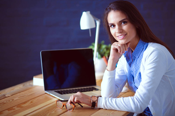 Young female working sitting at a desk. - Fotografie, Obrázek