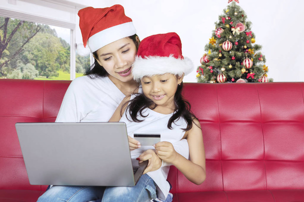 Little girl shopping online with her mother - Photo, image