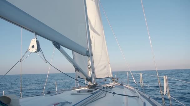 Front of the beautiful white sailing boat in the ocean. Yacht nose with white sail. Beautiful sea view on the sunny day - Footage, Video