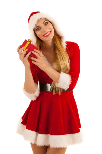 Beautiful young woman in santa claus dress hods a present isolat - Photo, Image