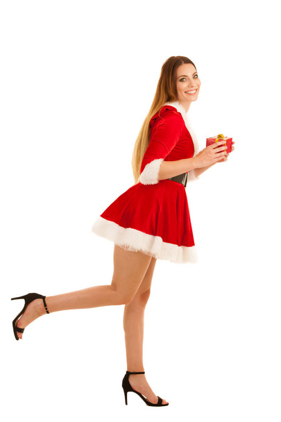Beautiful young woman in santa claus dress hods a present isolat - Foto, imagen