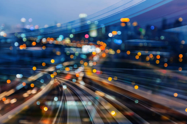 Zakřivené pohybu vlaku trať přes město noci rozmazané bokeh lehké  - Fotografie, Obrázek