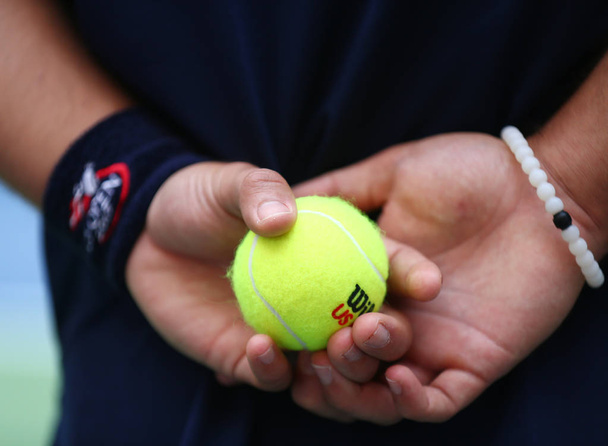 Ball boy holding Wilson tennis balls at the Billie Jean King National Tennis Center - Fotoğraf, Görsel
