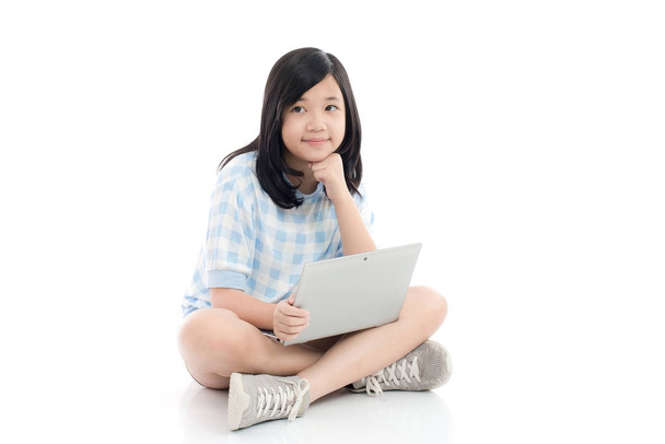 Happy Asian girl with laptop thinking, isolated on white background - Photo, Image