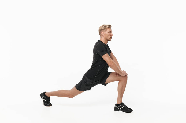 Sportive man stretching leg - Valokuva, kuva