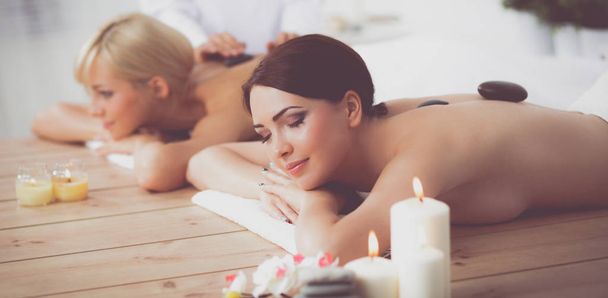 Two young beautiful women relaxing and enjoying at the spa center - Foto, immagini