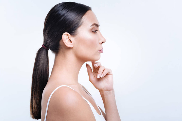 Side view of a beautiful dark-haired woman with pony tail - Photo, Image