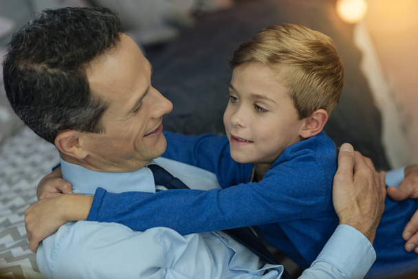 Positive father embracing his son - 写真・画像