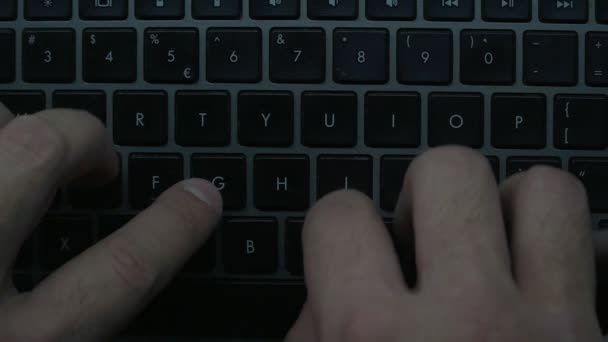Men's hands are typing on the laptop's keyboard. Slow motion. View from above - Footage, Video
