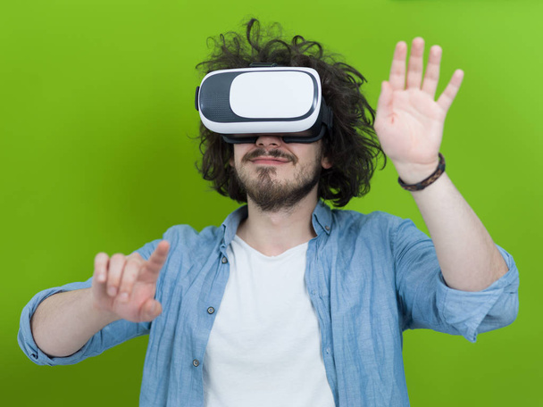 man using VR headset isolated on green background - 写真・画像