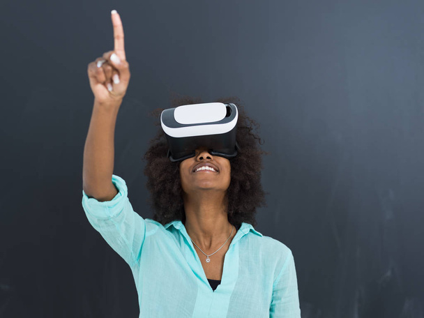 black girl using VR headset isolated on gray background - Foto, afbeelding