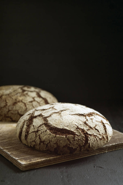 Rye bread on a black background. - Foto, Imagem