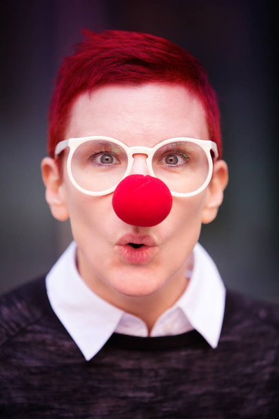 portrait of red-haired woman with red nose - Fotoğraf, Görsel