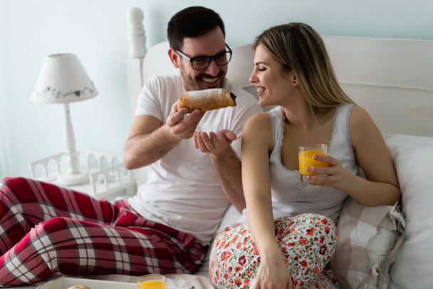 couple having breakfast together in bed - Фото, изображение