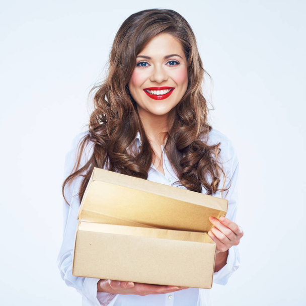 Toothy smiling young woman presenting  open box. - Foto, Bild
