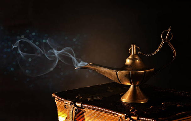 Image of magical aladdin lamp with glitter smoke. Lamp of wishes. - Фото, зображення