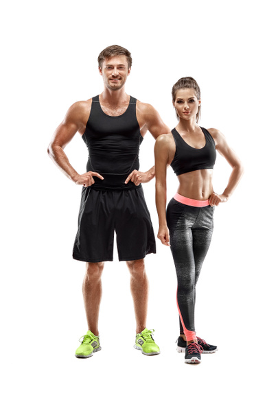 Sport, fitness, workout concept. Fit couple, strong muscular man and slim woman posing on a white background - Фото, изображение