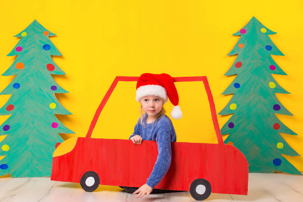 Child in red Christmas car. Xmas holiday concept - Фото, изображение
