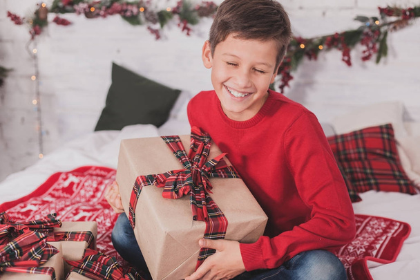Boy new year with presents in hands - Фото, изображение
