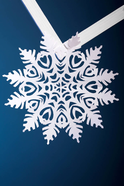 Winter style background.Paper snowflakes on blue background.Greeting card.Closeup - 写真・画像