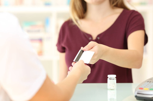 Customer giving credit card in a pharmacy - Фото, зображення