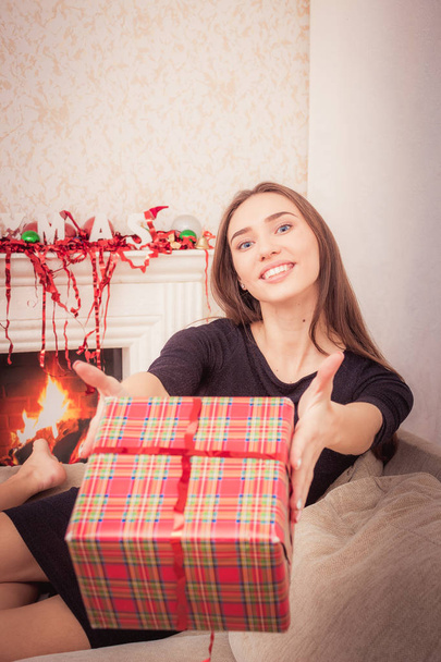 Smiling woman holds christmas tinsel - Fotoğraf, Görsel